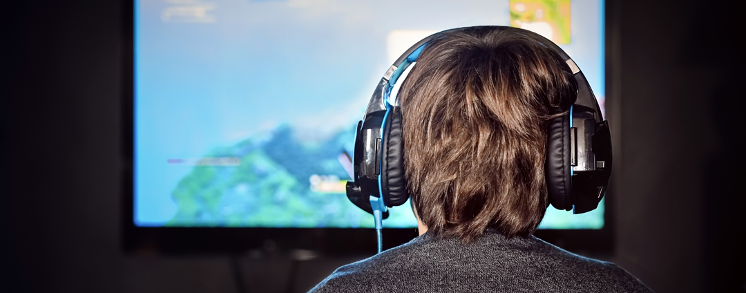 Picture of a teenage boy playing video games.