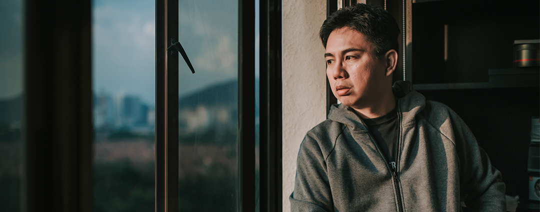 Man looking out window 
