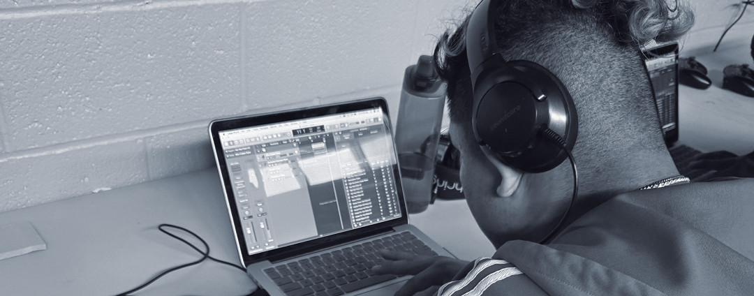 A youth using Nexus-Woodbourne's music studio equipment