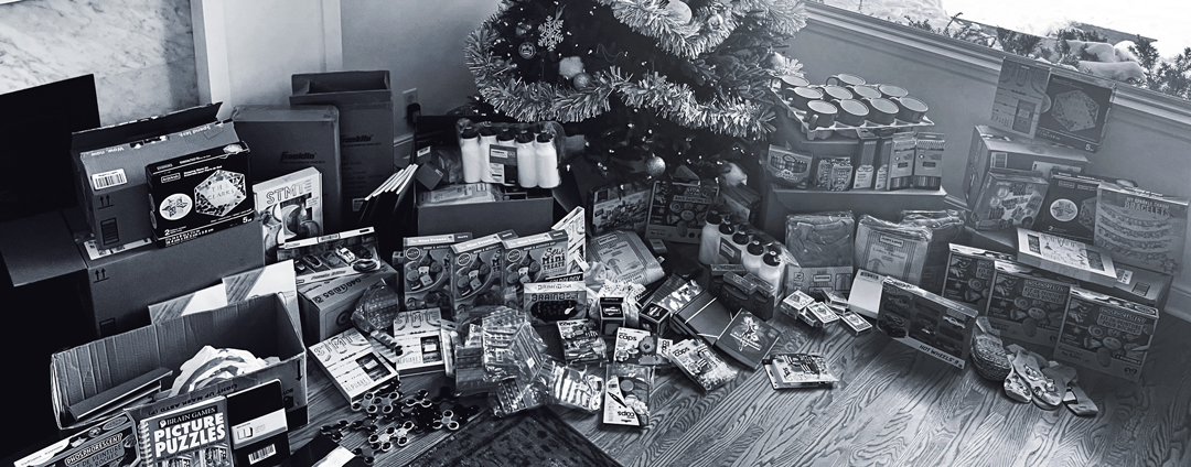 Photo of holiday gifts under a Christmas tree