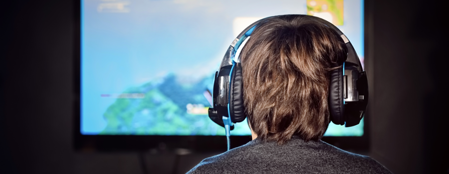 Picture of a teenage boy playing video games.