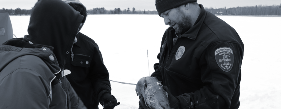 Onamia Conversation Officer Dan Starr teaches youth tips on ice fishing