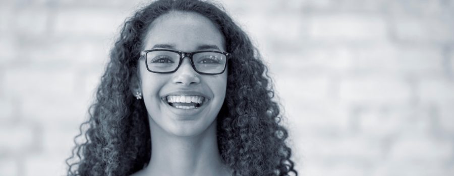 Teenage girl with glasses smiling