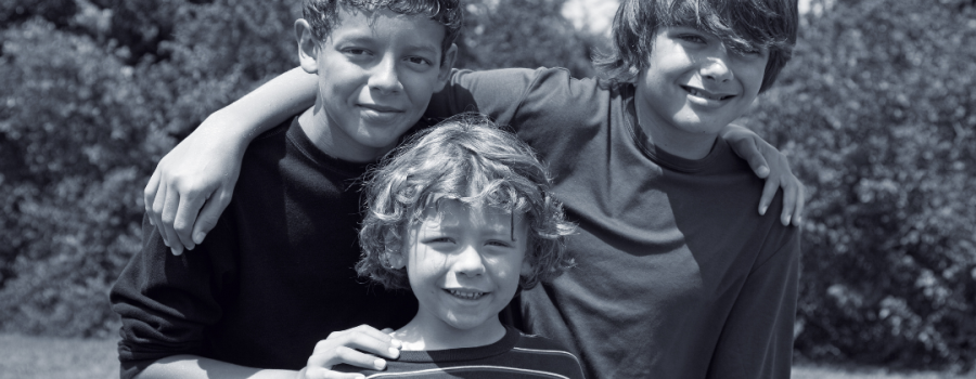three brothers posing for picture
