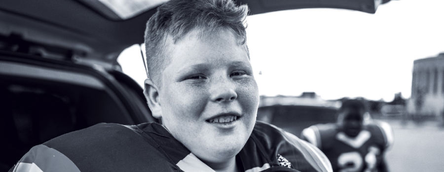 teenage boy in his football gear