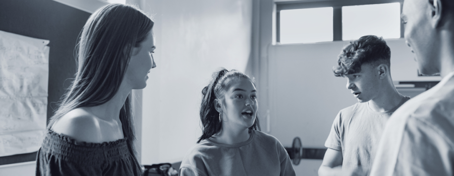 Four teenage youth having a conversation together.