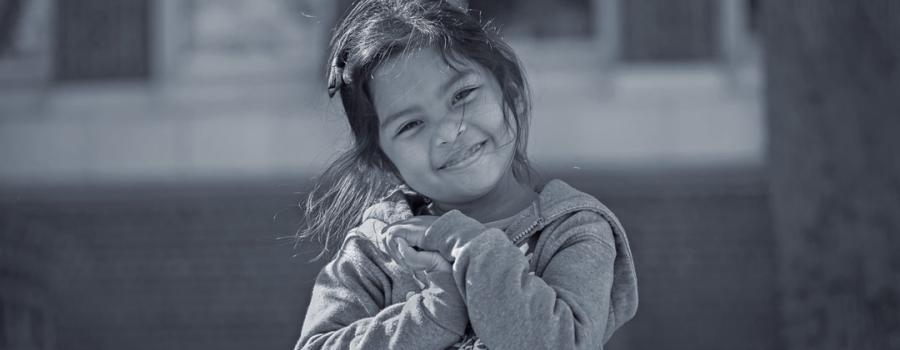 Charlotte, a young five year old girl, smiling at the camera.