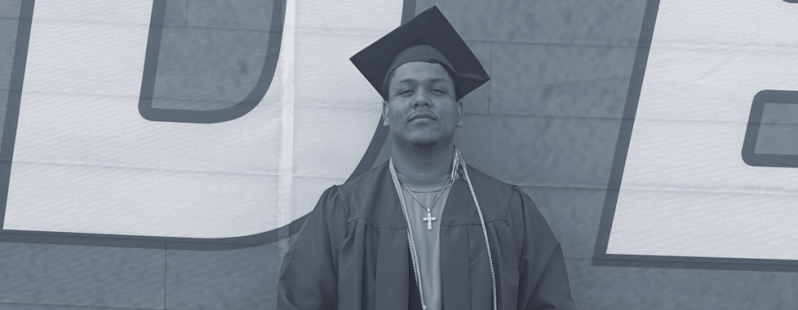 Robin in his cap and gown, holding his high school diploma