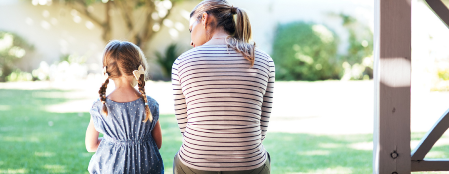 Respite - female adult sitting on a porch step and talking with a young child