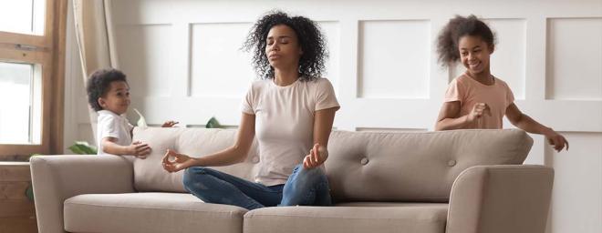 Photo of a woman meditating on a couch