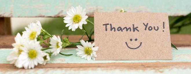 Picture of a thank you card next to some flowers