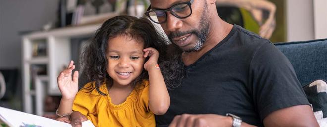 Picture of a parent sitting down and spending time with their child.