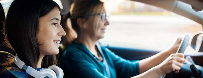Parent and teen driving in the car together