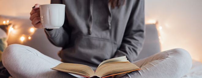 Women reading book in bed