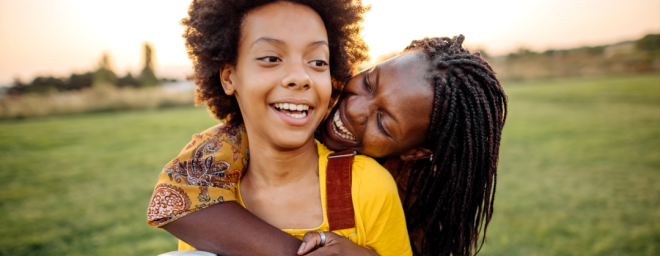 Foster parent hugging a child.