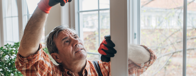 Photo of a man repairing a door