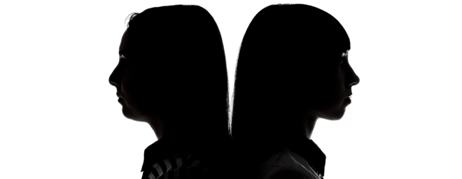 Sisters standing back to back.