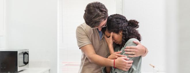 Husband and wife grieving a miscarriage