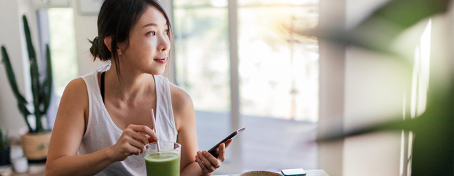 A woman drinking a smoothie