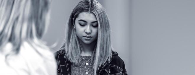 Teenage girl talking through her emotions with therapist