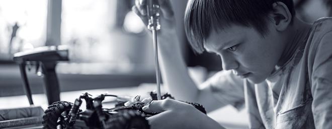 Sam tinkering with a toy car