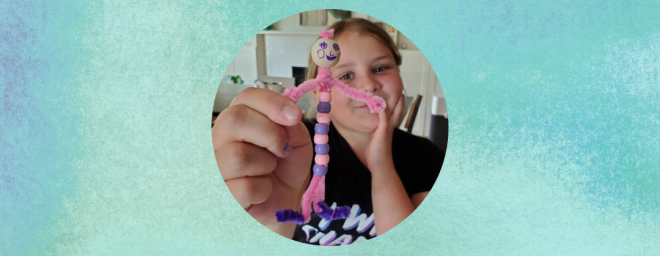 Young girl holding up her worry buddy