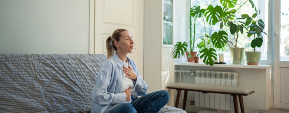 woman self-soothing with deep breaths with hand on chest