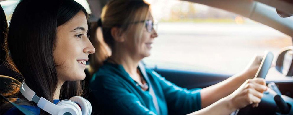 Parent and teen driving in the car together