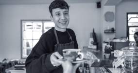 Youth serving coffee