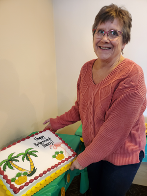 Nancy Kagel holding her retirement cake