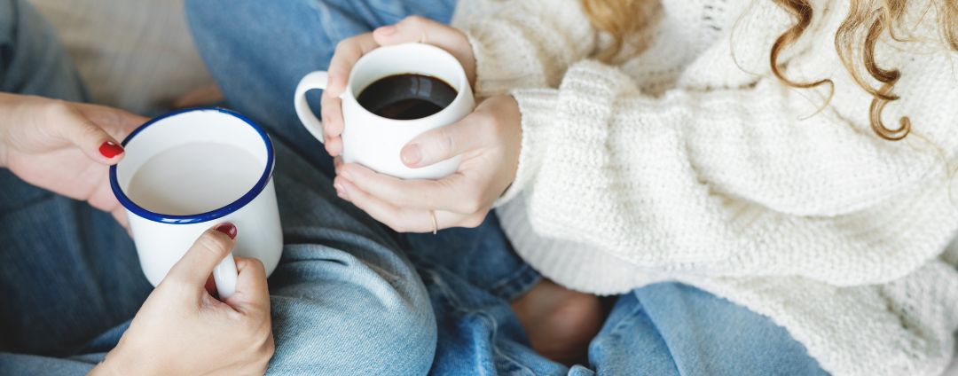 Two people sitting together with coffee.