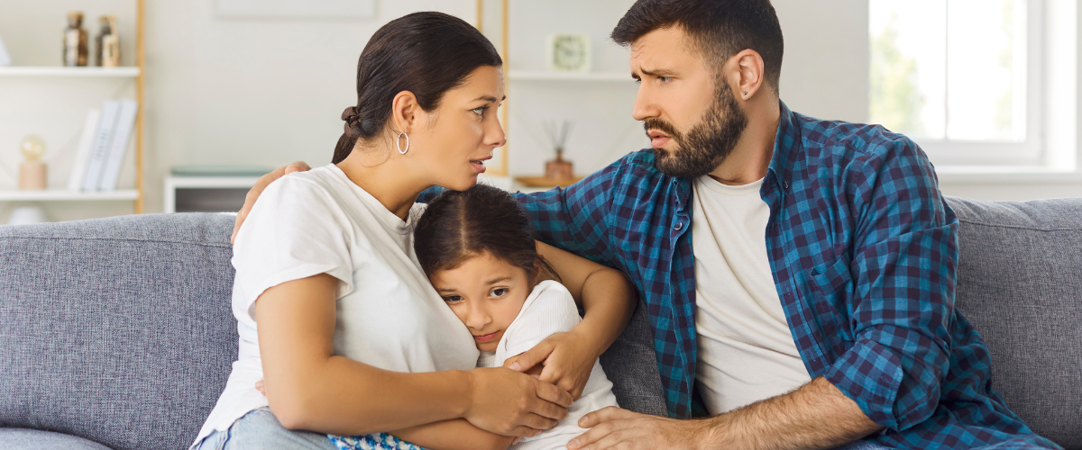 parents comforting a worried child