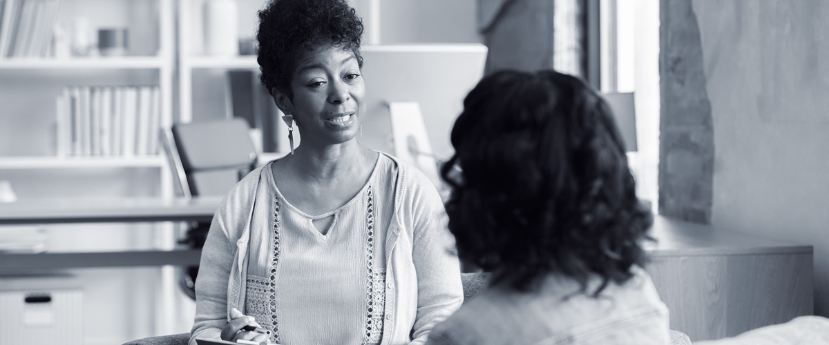 Therapist talking to youth in foreground