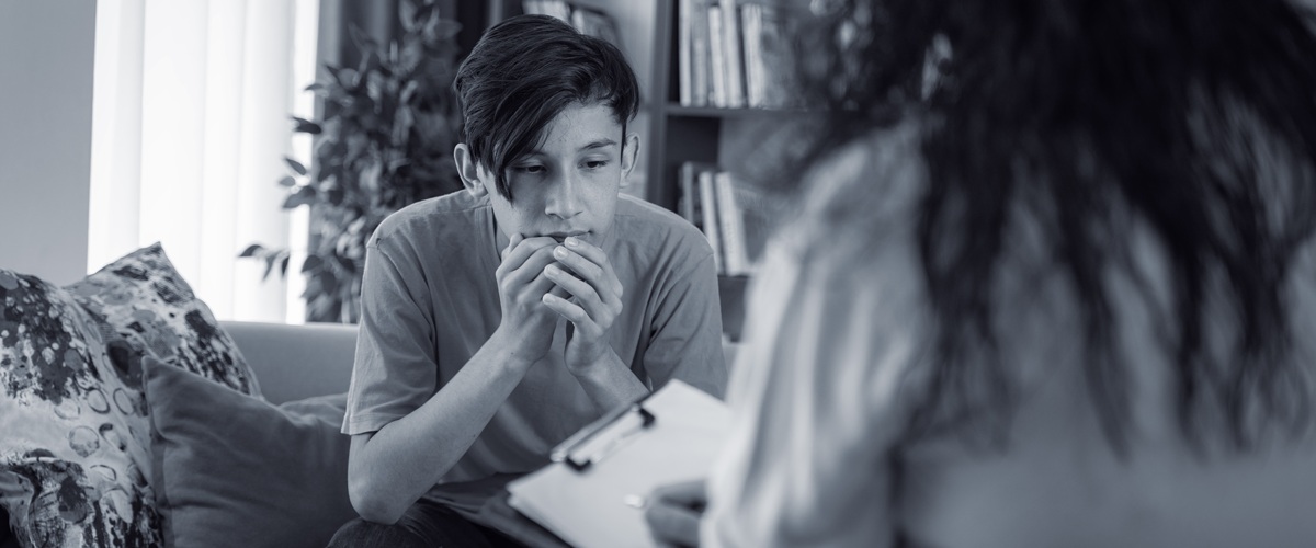 Nervous teen with hand below mouth