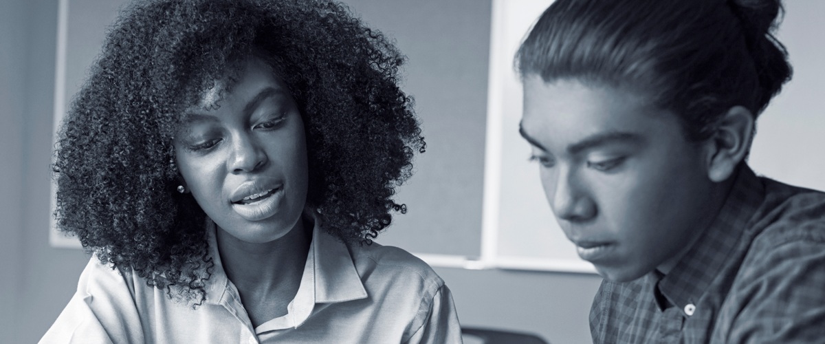 Female therapist talking with male youth