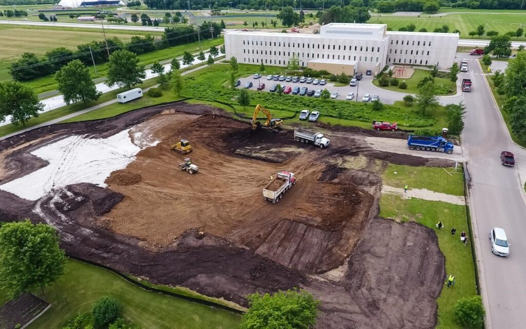 Construction area showing trucking hauling and leveling dirt