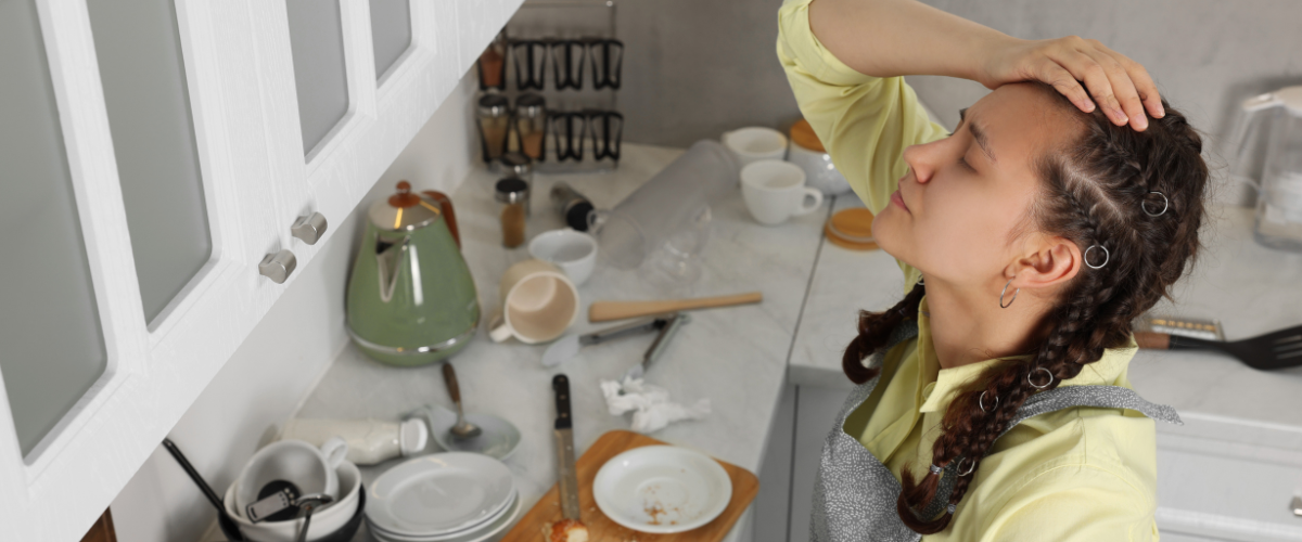 Woman stressed in a messy kitchen