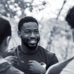 Male adult chatting and interacting with teenagers.